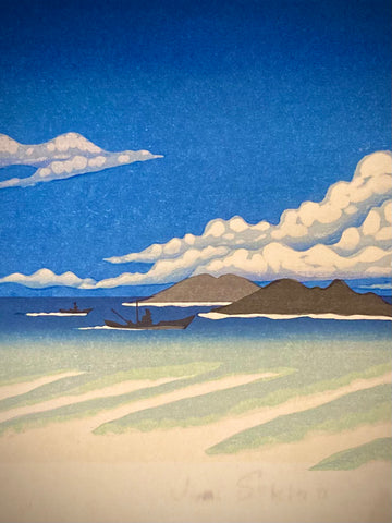 Close-up of two small fishing boats floating on a calm, blue sea beneath a partly cloudy sky.