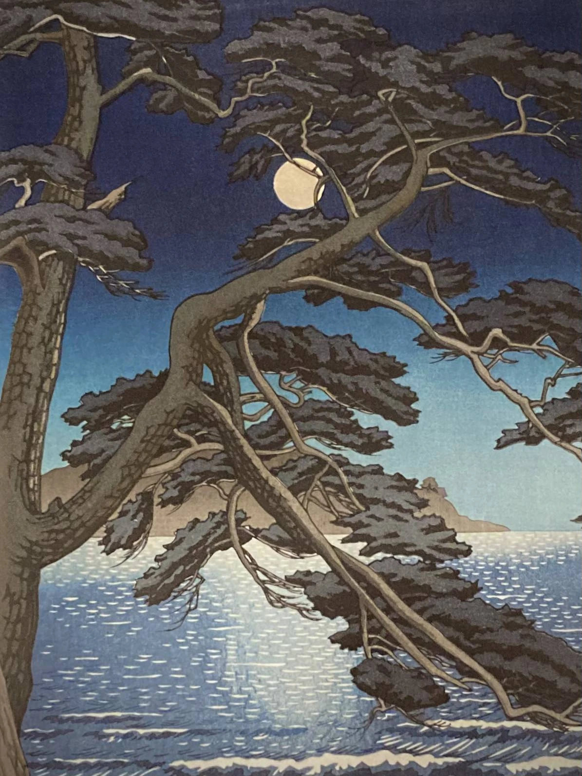 Close-up of Japanese art print by Kawase Hasui showing detailed pine tree branches and soft moonlight reflecting over the sea in a tranquil night scene.