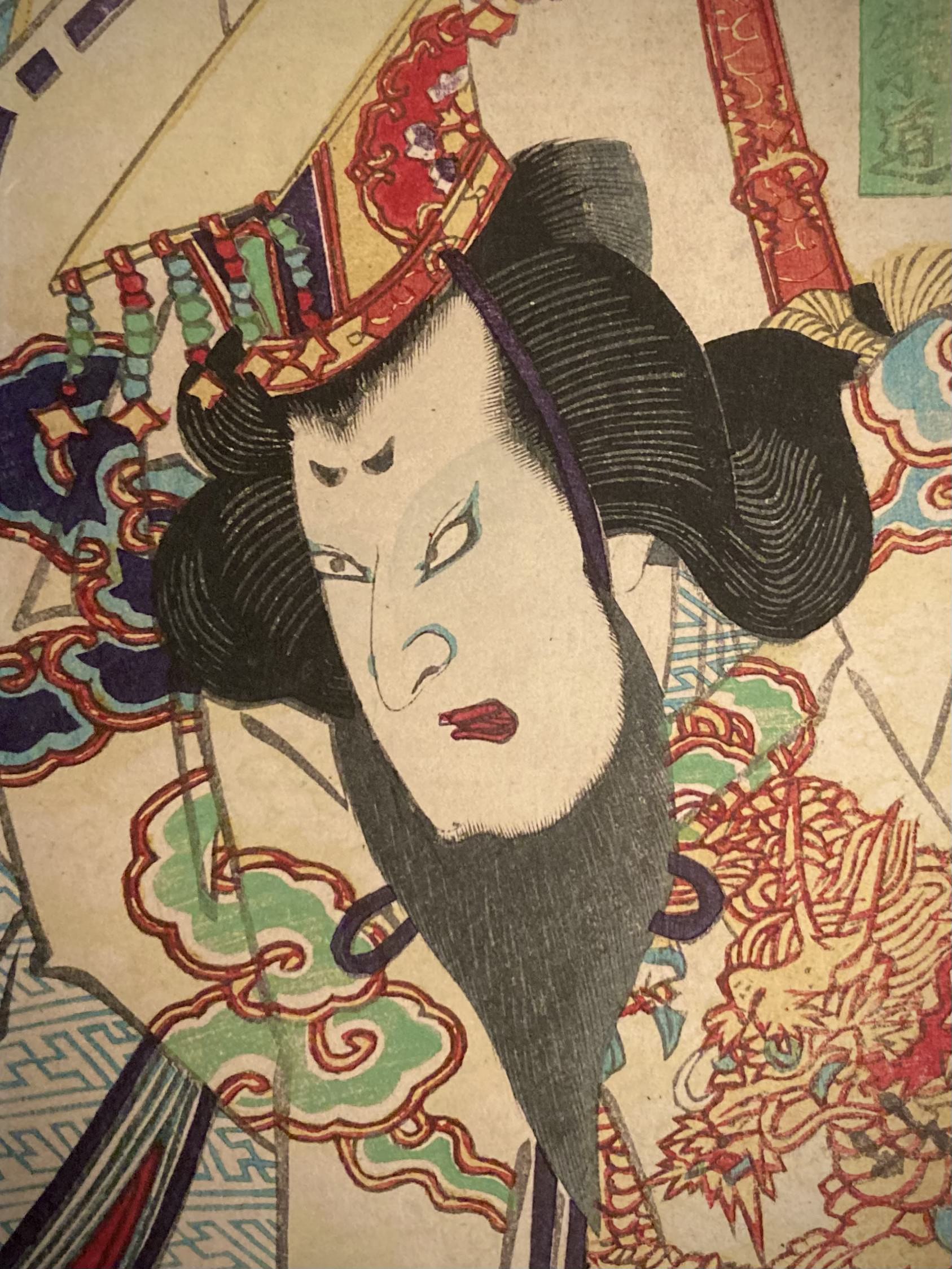 Close-up of a Japanese art print highlighting the Kabuki actor’s fierce expression, elaborate dragon robe, and detailed headdress from a classic Ukiyo-e scene.