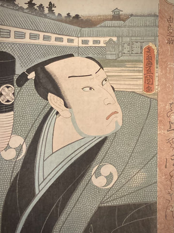 Close-up of Utagawa Kunisada’s ukiyo-e print showing kabuki actor Oboshi Yuranosuke’s intense facial expression, topknot hairstyle, and crest-adorned kimono with teal and black details.